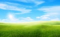 Green grass natural meadow field and little hill with white clouds and blue sky in summer seasonal. Royalty Free Stock Photo