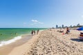 Beautiful landscape view of Miami South Beach coast line. Sand beach, Atlantic Ocean, people on blue sky background. USA.