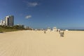 Beautiful landscape view of Miami South Beach coast line. Sand beach, Atlantic Ocean, people on blue sky background. USA.