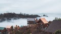 Beautiful landscape view of Mountain cabins above the low clouds with rural houses
