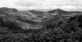 Beautiful landscape view of mountain. Forest or jungle with mountain heel and cloud sky in black and white style.