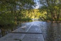 Beautiful landscape view of river with bridge and green forest trees on both sides. Royalty Free Stock Photo