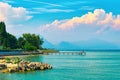 Beautiful landscape view of summer lake Garda in Italy with turquoise water and amazing pink evening clouds Royalty Free Stock Photo