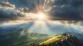 A beautiful landscape view with sun beams through clouds from the top of a mountain. Royalty Free Stock Photo