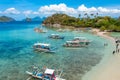 Beautiful landscape view of a tropical Snake island with tourists and boats, El Nido, Palawan, Philippines.