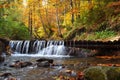 Beautiful landscape with a waterfall in the autumn forest. Autumn sunny day Royalty Free Stock Photo