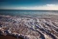 Beautiful landscape, wave with white foam running on sandy shore Royalty Free Stock Photo