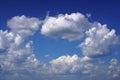 A beautiful landscape, white cumulus clouds float across the sky and formed a closed circle on it Royalty Free Stock Photo