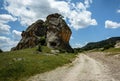 Beautiful landscape with a winding dirt road under blue skies wi Royalty Free Stock Photo