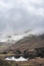 Beautiful landscape Winter sunrise of Blea Tarn from Side Pike in English Lake District with low level clouds over mountain tops Royalty Free Stock Photo