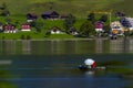 beautiful landscapes of Switzerland , boat in the sea , huts in the lush green valley