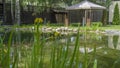 Beautiful landscaping with pond, plants and gazebo. Backyard garden landscaping. Landscape design.