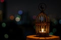 Beautiful Lantern that have moon symbol on top with city bokeh light on dark background