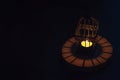 Beautiful Lantern that have moon symbol on top that have light from candle shining on wooden tray with dark background