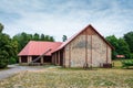 A beautiful large barn at the horse farm in Florianka. Red corrugated metal sheet on the roof of the barn Royalty Free Stock Photo