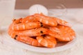 beautiful large boiled tiger prawns on a white plate on the kitchen table Royalty Free Stock Photo