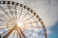 Beautiful large Ferris wheel against blue cloudy sky on sunny day, low angle view Royalty Free Stock Photo