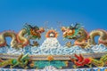 Beautiful large grimace dragons crawling on the decorative tile roof in Chinese temples. Colorful roof detail of traditional Chine Royalty Free Stock Photo