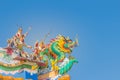 Beautiful large grimace dragons crawling on the decorative tile roof in Chinese temples. Colorful roof detail of traditional Chine Royalty Free Stock Photo