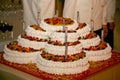 Beautiful large multi-tiered wedding cake of complex shape. Royalty Free Stock Photo