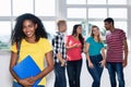 Beautiful latin american female student with group of other young adults Royalty Free Stock Photo