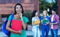 Beautiful latin american female student with group of students Royalty Free Stock Photo