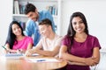 Beautiful latin american female student learning with group of students Royalty Free Stock Photo