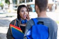 Beautiful latin american female student talking with male student in city Royalty Free Stock Photo