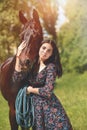 Beautiful Latin woman in dress and her lovely horse walk in the forest. love animals concept. love horses