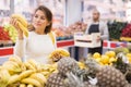 Beautiful latin woman in produce section of supermarket