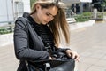 Beautiful Latin woman searching her purse for her wallet, realizing that it was stolen