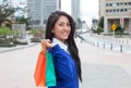 Beautiful latin woman with shopping bags in the city Royalty Free Stock Photo