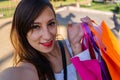 Beautiful Latin woman taking a selfie showing her shopping bags. Technology, shopping concept. View from the cell phone camera Royalty Free Stock Photo