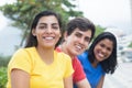 Beautiful latin woman in a yellow shirt with friends Royalty Free Stock Photo