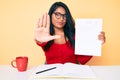 Beautiful latin young woman with long hair showing a failed exam with open hand doing stop sign with serious and confident Royalty Free Stock Photo