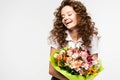 Beautiful laughing curly girl holding bouquet
