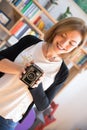 Beautiful laughing girl with a vintage film camera