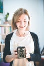 Beautiful laughing girl with a vintage film camera