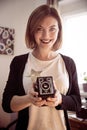 Beautiful laughing girl with a vintage film camera