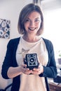 Beautiful laughing girl with a vintage film camera