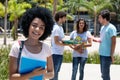 Beautiful laughing latin american female student with group of s Royalty Free Stock Photo