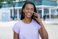 Beautiful laughing latin american woman talking at phone with boyfriend Royalty Free Stock Photo