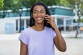 Beautiful laughing latin american woman talking at phone with boyfriend Royalty Free Stock Photo