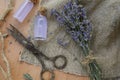 Beautiful lavender flowers, bottles of essential oil and scissors on wooden table, flat lay Royalty Free Stock Photo