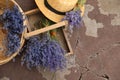 Beautiful lavender flowers and straw hat on cement floor outdoors. Space for text Royalty Free Stock Photo