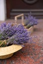 Lavender flowers and straw hat on marble tiles outdoors