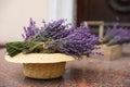 Beautiful lavender flowers and straw hat on marble tiles outdoors