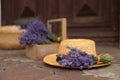 Beautiful lavender flowers and straw hat near building outdoors Royalty Free Stock Photo