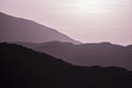 Beautiful layered mountain landscape image with magenta light at sunrise