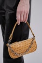 Beautiful leather brown handbag in girl`s hand. Royalty Free Stock Photo